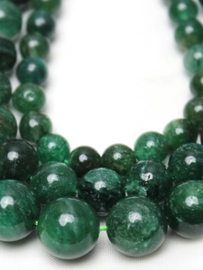 Macro close-up of natural green mica beads showing smooth texture for DIY jewelry