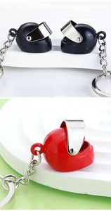 Close-up of 3D mini motorcycle helmet keychains with movable visor in red and black