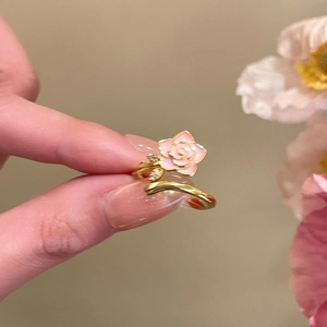 Macro shot of 18k gold-plated open ring featuring a pink enamel rose and zircon stones