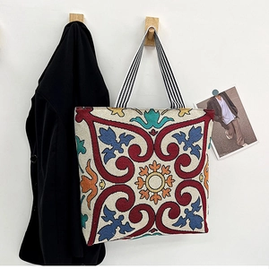 Detail of vintage embroidered canvas tote bag with colorful ethnic jacquard patterns