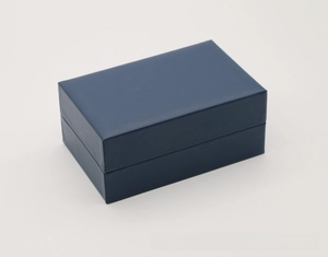Detail view of navy blue rectangular PU leather watch box with fine textured finish