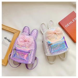 Detail view of purple and white sequined children backpacks with bunny ears and mesh bow