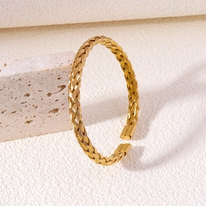 Handcrafted gold twisted cable cuff bracelet in stainless steel with textured wheat pattern