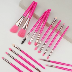 Professional 14-piece makeup brush set with bright pink handles and synthetic bristles