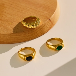Retro luxury gold rings set featuring emerald and black stones with twisted band textures
