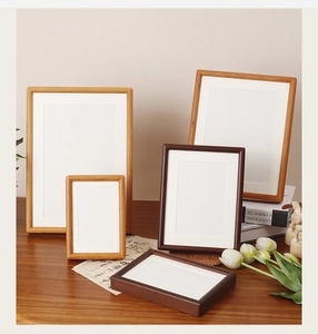 Detail of solid walnut wood frames in varied sizes and finishes for wall or tabletop