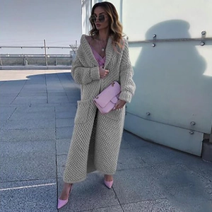 Winter long knit cardigan in beige featuring a lapel collar and large side pockets on model
