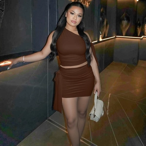 Detail of a brown two-piece set featuring a one-shoulder top and ruched mini skirt