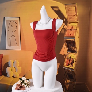 Detail of red ruched square neck tank top with elegant side gathering on a mannequin