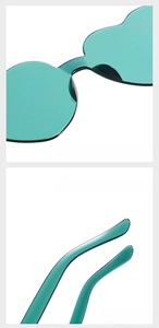 Detail of mint green heart-shaped sunglasses showing comfortable nose pads and temple tips