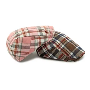 Classic vintage plaid newsboy caps in pink and coffee colors on a white background
