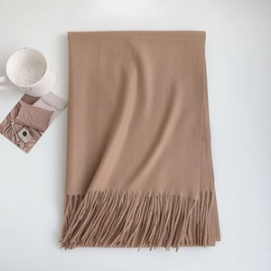 Detail showing high-quality camel faux cashmere scarf with soft fringe texture