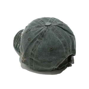 Detail view of washed distressed cotton baseball cap with side embroidery and metal buckle