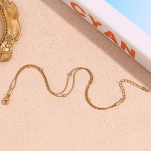 Elegant 18K gold-plated double-layer snake chain bracelet with metallic beads
