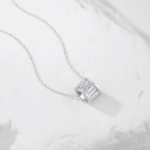 S925 sterling silver necklace with a cylindrical pavé cubic zirconia pendant on white stone