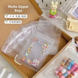 Frosted self-sealing bags for cartoon stickers and cards in a cozy desktop setting