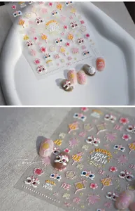 Detail of 3D embossed nail stickers featuring Lunar New Year 2025 motifs and gold accents