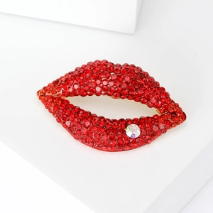 Sparkling red rhinestone lip brooch with a large crystal accent on a gold base