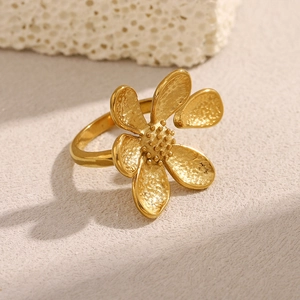 Close-up of vintage flower open ring in 18K gold plated stainless steel on stone