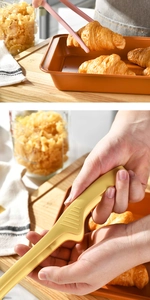 Detailed view of pink and yellow silicone food tongs picking up a fresh croissant