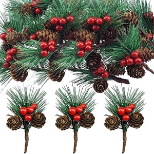 Detail of festive pine needle garland with natural pine cones and red holly berries set