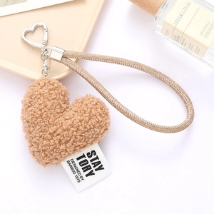 Brown plush heart keychain with woven strap and silver hardware for bags and phones