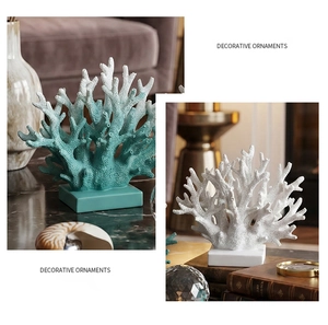 Artistic close-up of resin coral ornaments in white and teal with square bases