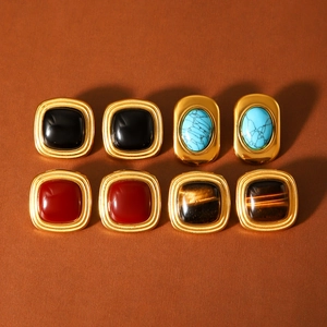 Detailed display of vintage square gold earrings with multi-color gemstone inlays