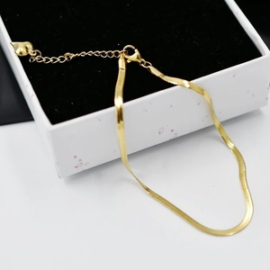 Sleek gold-plated stainless steel snake chain anklet with a heart pendant on white box
