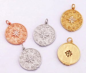 Detail view of celestial zodiac charms in gold, silver, and rose gold with zircon inlay