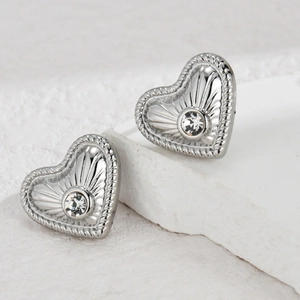 Silver heart stud earrings with sparkling crystal and radiating texture design