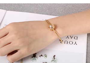 Close-up of a stylish 18k gold-plated bangle featuring a square-cut champagne zircon