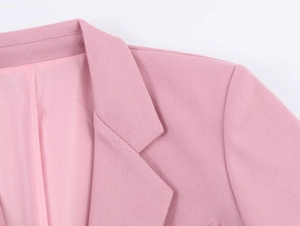 Detailed close-up of pink oversized blazer showing lapel collar and shoulder stitching