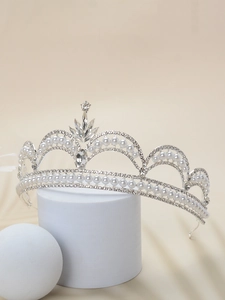 Detailed view of silver bridal crown with white pearls and sparkling rhinestones
