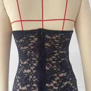 Detailed back view of sexy black lace backless dress featuring a zipper and slim straps