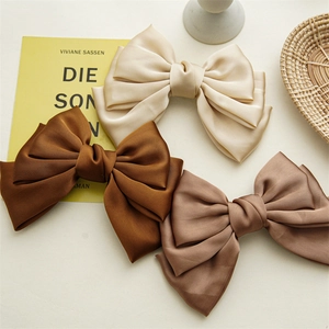 Three-layer satin oversized bow hair clips in autumn earth tones for a French style look