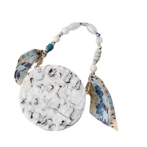 Chic marble pattern round clutch with beaded handle and floral silk scarf accessory