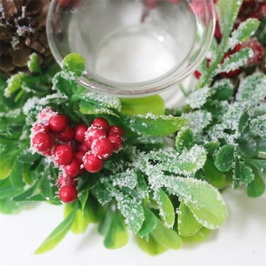 Christmas wreath candle holder with red berries, pine cones and artificial snow effects