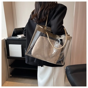 Transparent PVC tote bag with canvas inner pouch and rope handles on a shoulder model