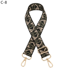 Close-up of ethnic geometric adjustable strap with golden metal clips in green