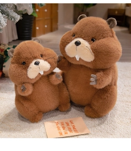 Detailed view of two soft brown plush marmot dolls with cute white teeth on a rug