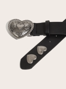 Detail of punk leather belt with heart-shaped embossed metal buckle and rivets