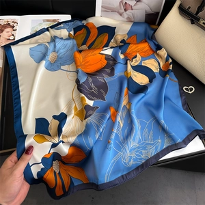 Elegant floral silk scarf in blue, white and orange pattern for a stylish feminine look