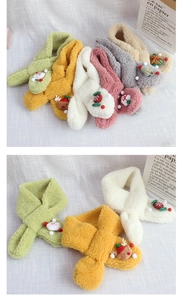 Detail view of colorful plush Christmas scarves for children with various cute 3D cartoon icons