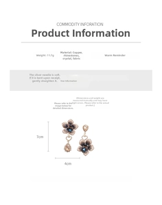 Detail of vintage pink fabric flower earrings with crystal accents and heart drop pendants