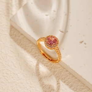 Detail of flower-shaped 18K gold-plated ring with pink zircon and micro-set diamonds