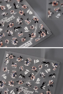 Macro view of floral relief nail stickers with blue and pink flowers and green leaves