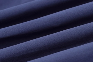 Detailed close-up of navy blue twill fabric texture showing weave and draping detail