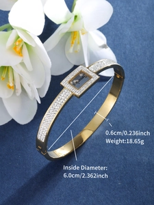 Detailed macro view of gold-plated stainless steel bracelet with Forever Love engraving