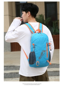 Outdoor foldable backpack in blue and orange featuring breathable side mesh pockets